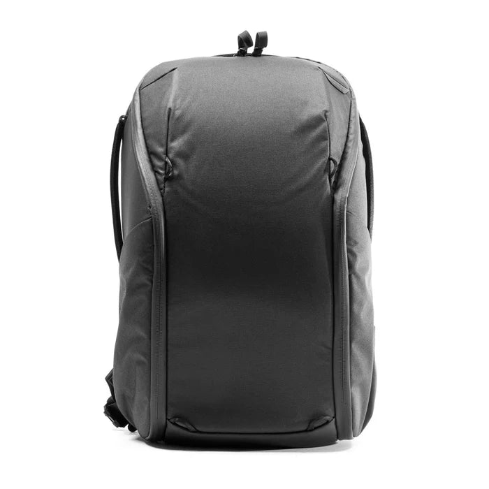 A dark gray backpack shown from the back, featuring a structured shape, padded top handle, and side straps, photographed against a solid white background.