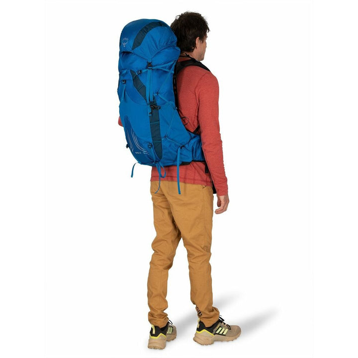 Person wearing a large blue backpack on a white background
