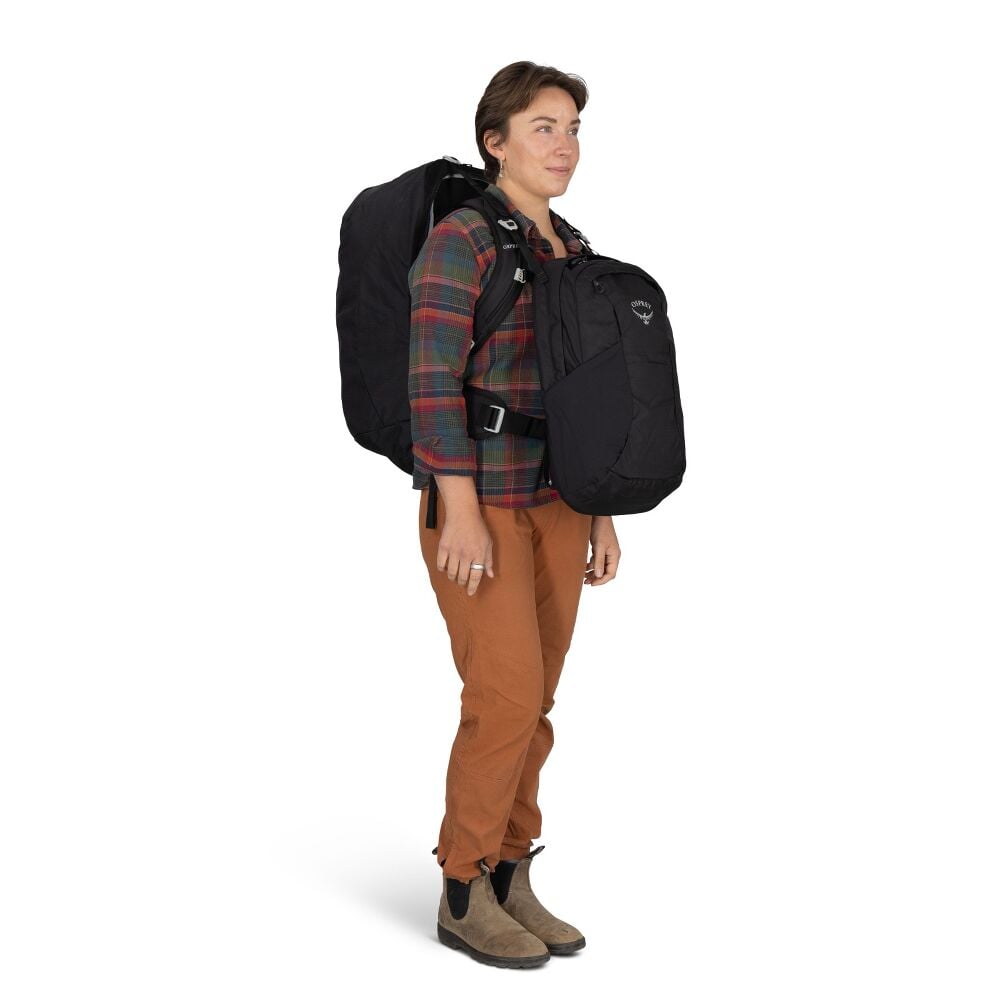Person wearing a black backpack and front facing pack on white background
