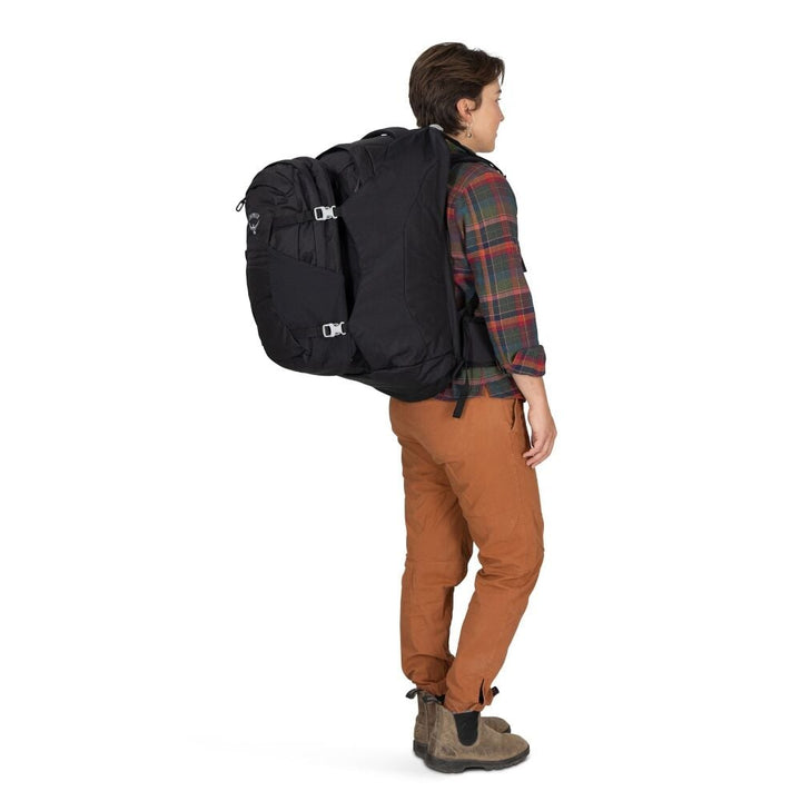Person wearing a black backpack on a white background