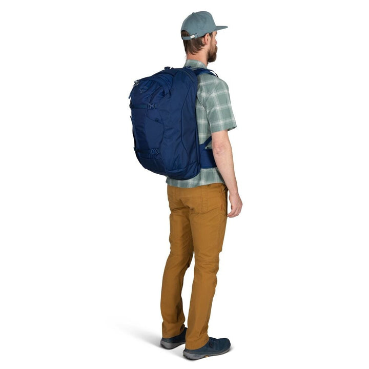 Man wearing a blue backpack on a white background