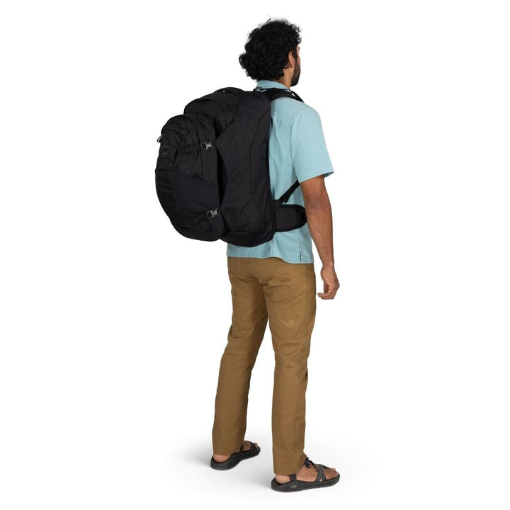 Man wearing a black backpack on a white background