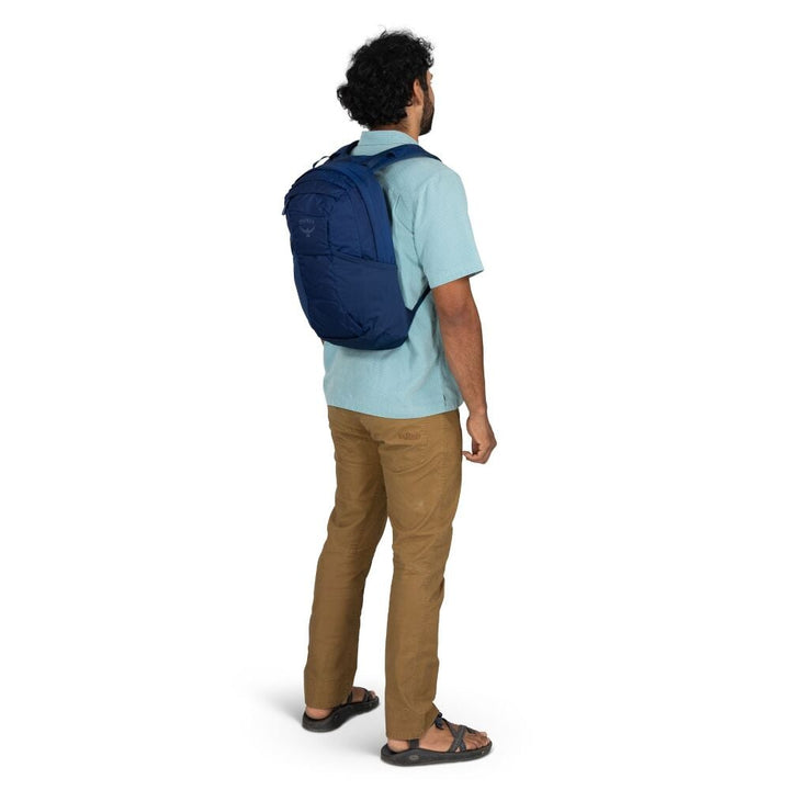 Man wearing a blue backpack on a white background