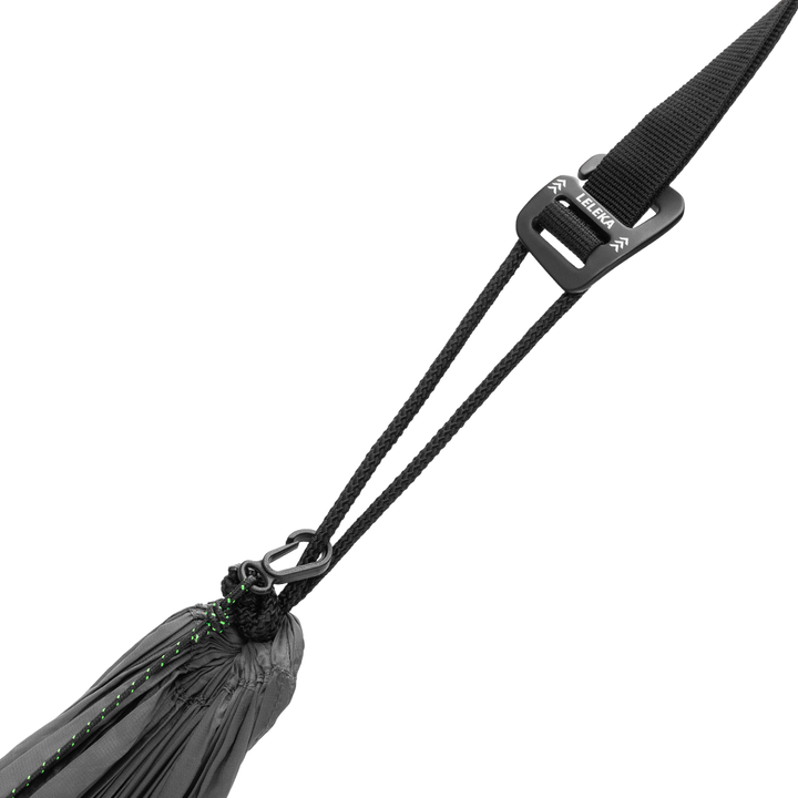 Close-up of a black adjustable nylon strap with a black plastic quick-release buckle and a metal carabiner, attached to a black hammock bag, on a solid white background.