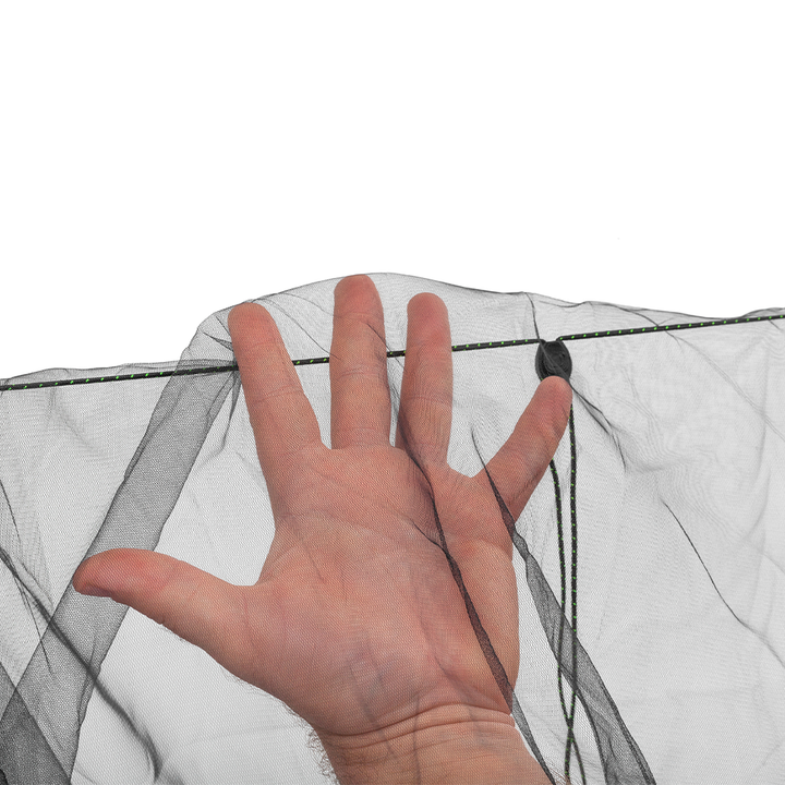 A hand is shown behind a white mesh screen or tent fabric to demonstrate transparency and fit, with a black cord and small black ring visible against a plain white background.