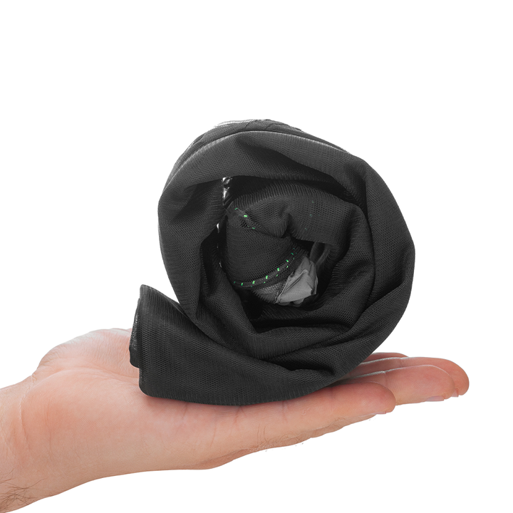 Black fabric rolled up being held in a hand on a white background