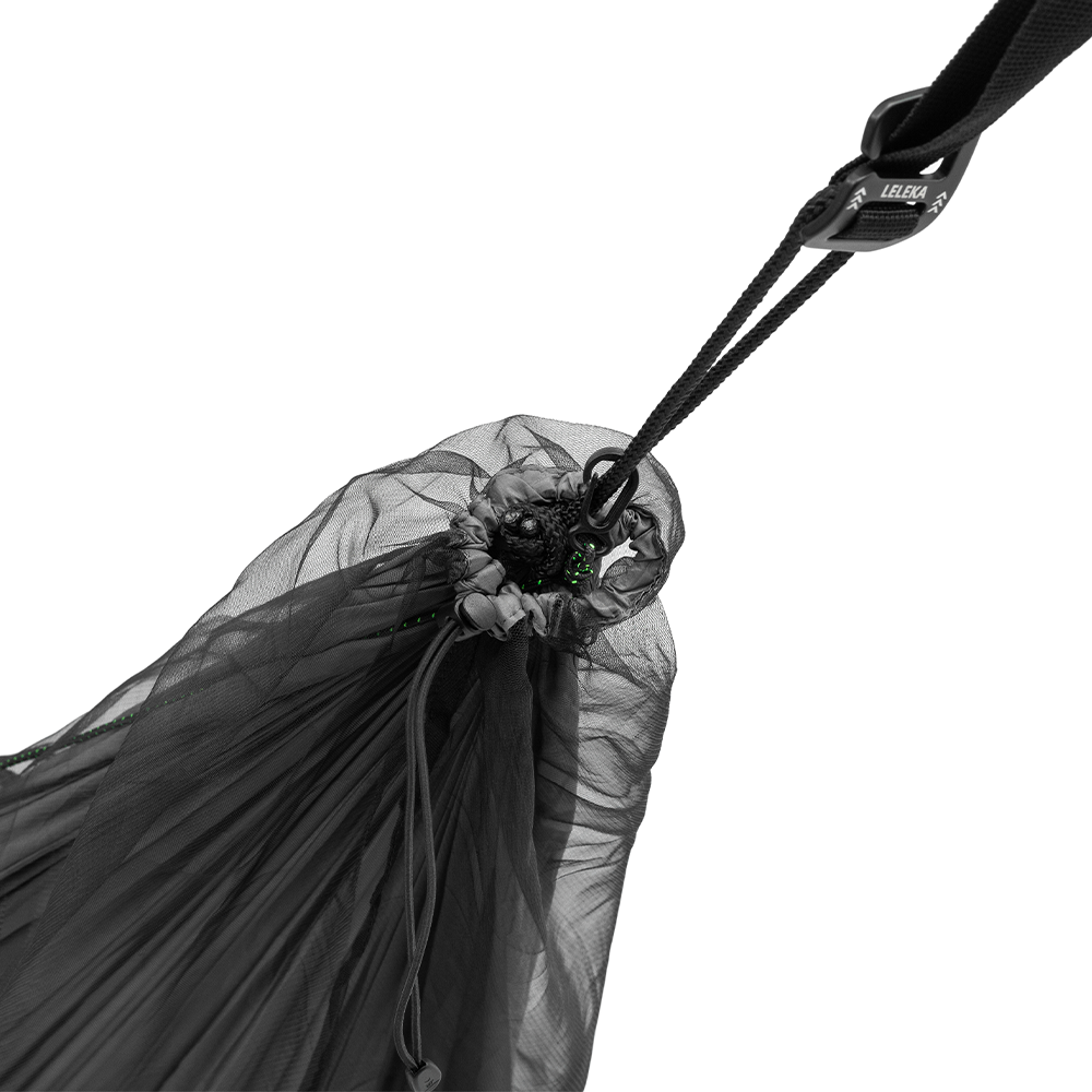 Close-up of a black hammock suspension system with straps on a beige background
