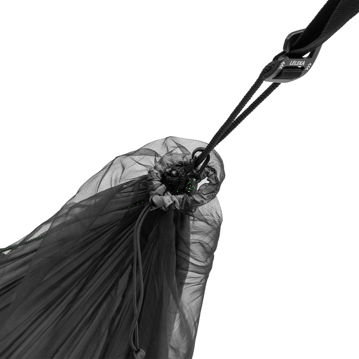 Close-up of a black hammock suspension system with straps on a beige background