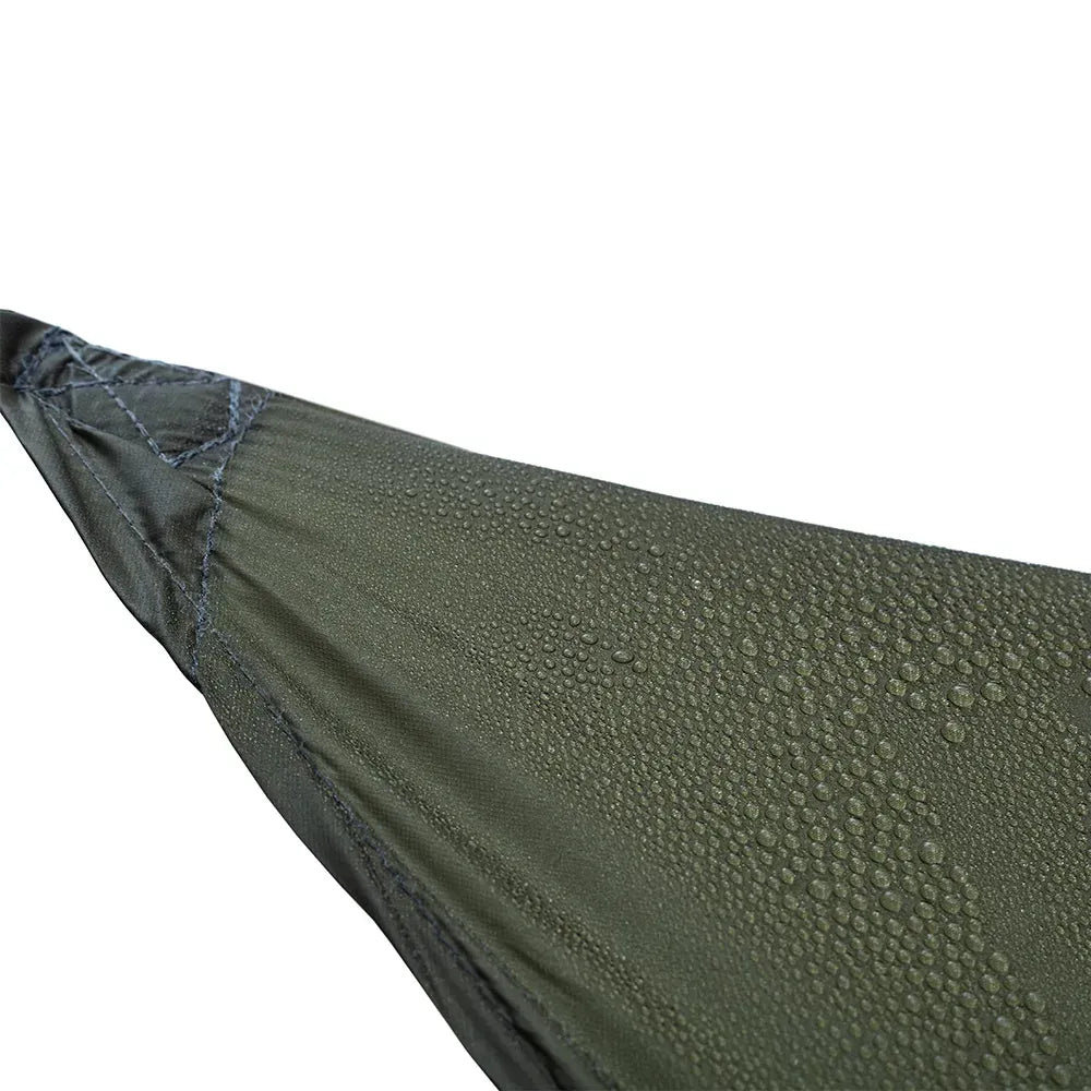 Close-up of an olive green fabric surface with water droplets on a white background, showing a textured material and stitched edge.