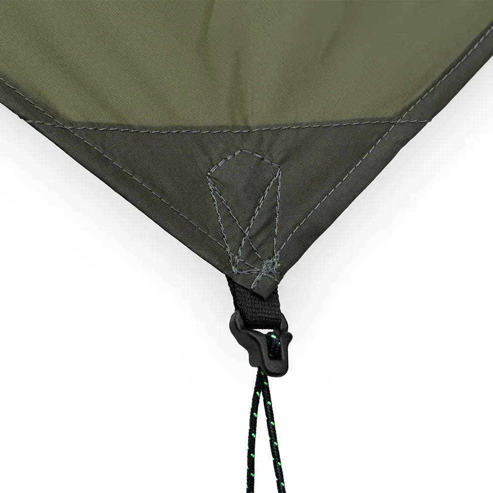 Close-up of an olive green tent or tarp corner with dark gray stitching, a black plastic hook-and-loop fastener, and a black-and-green drawcord on a white background.