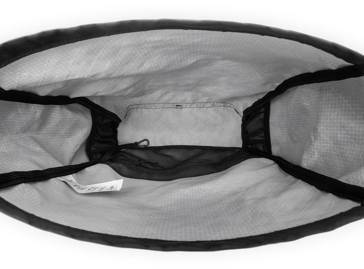 Close-up of a gray mesh bag with black drawstrings on a white background