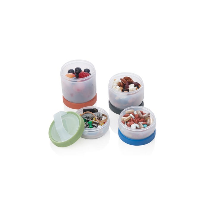 Set of small containers with colorful lids filled with various items on a white background
