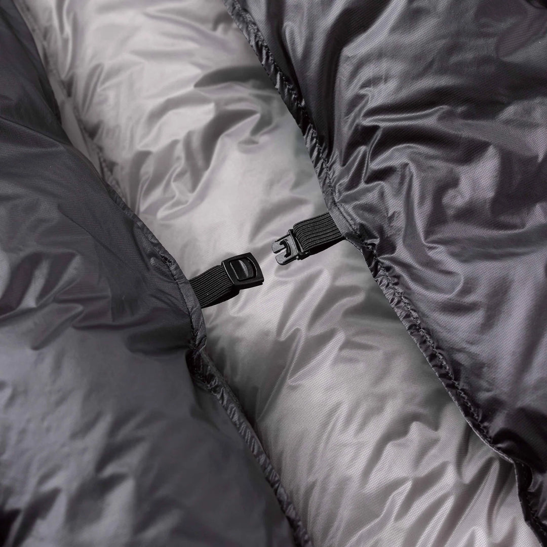 Close-up of a gray quilt with a black buckle detail