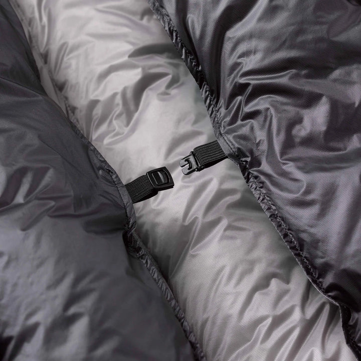 Close-up of a gray quilt with a black buckle detail