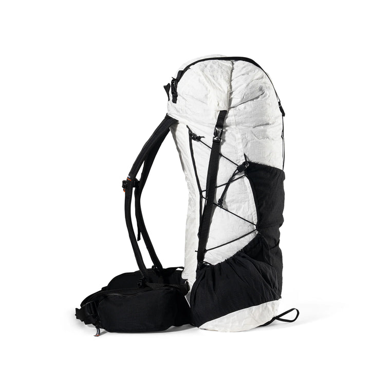 A technical outdoor backpack shown from the side against a plain white background. The backpack features a white upper body with black compression straps and a black lower compartment and shoulder straps.