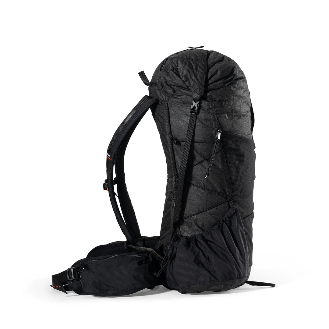 A black technical outdoor backpack shown from the side against a clean white background.