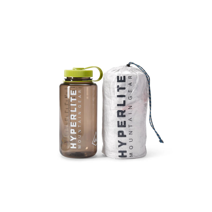 Brown water bottle and white compression sack with &