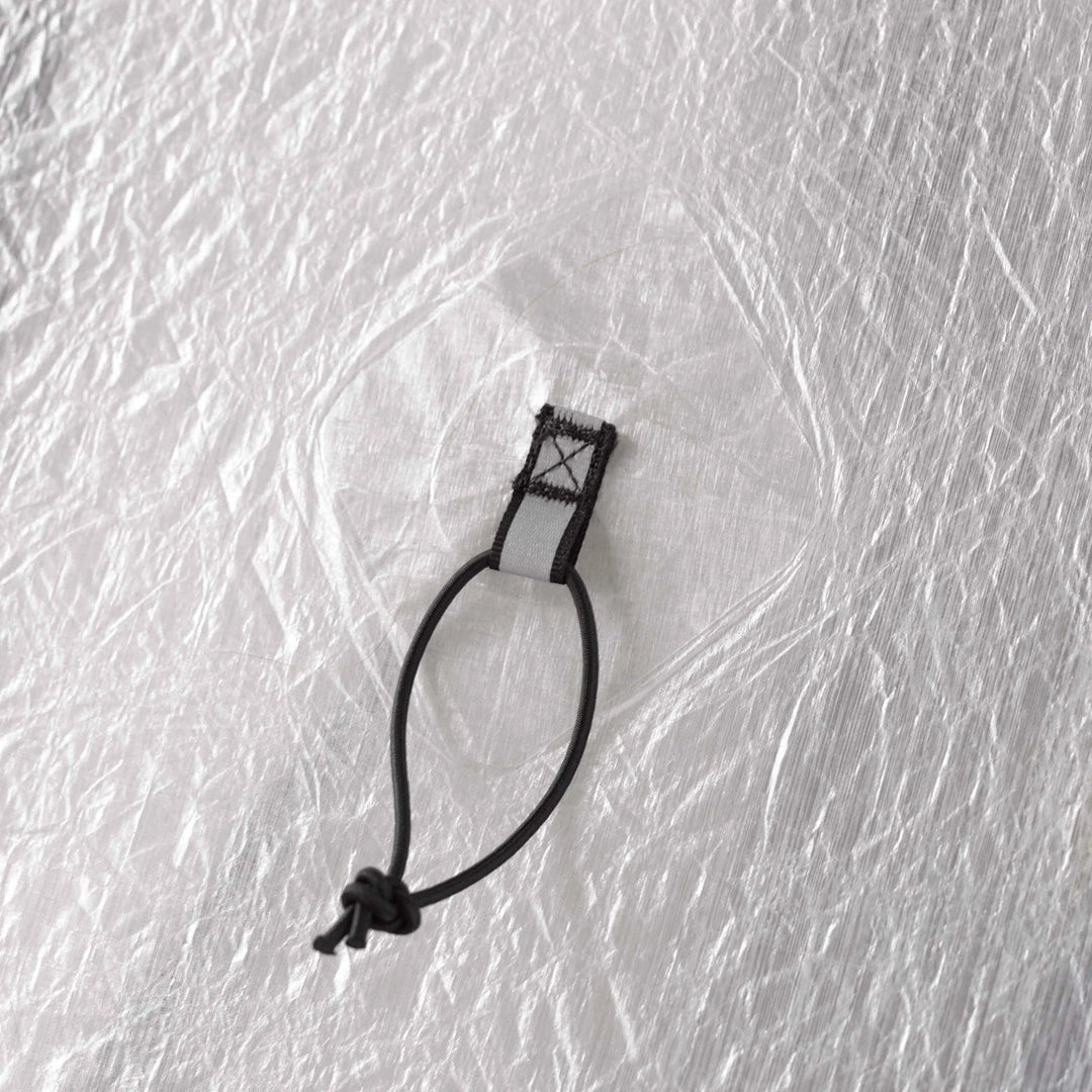 Close up of a black loop attached to white  tent 