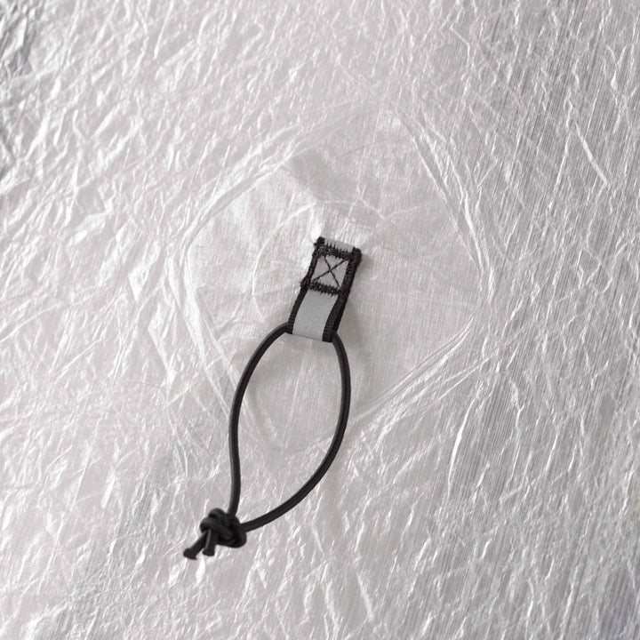 Close up of a black loop attached to white  tent 