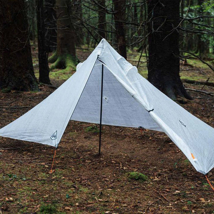 Camping tarp set up in a forest setting