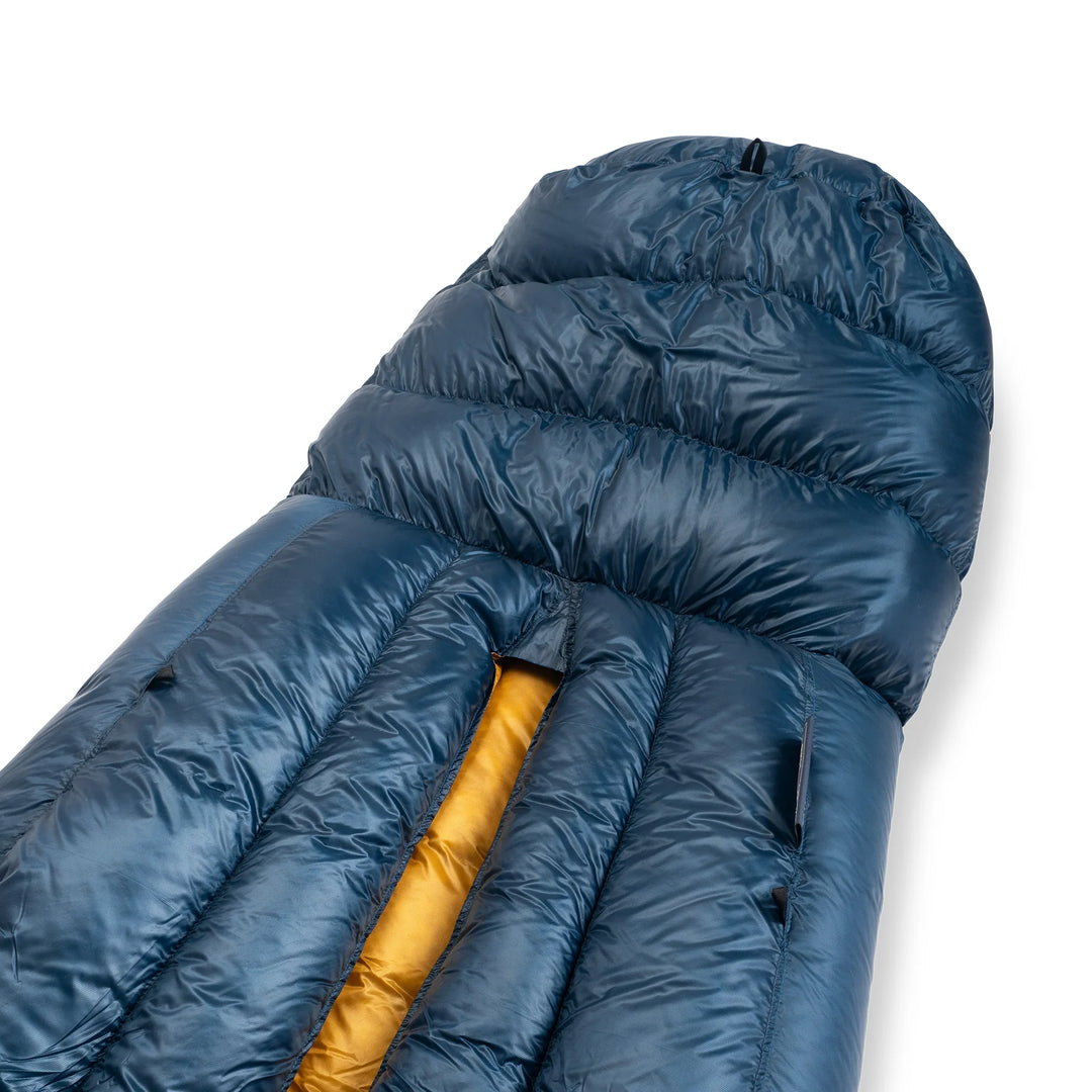 Blue sleeping bag with yellow interior on a white background