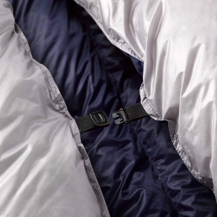 Close-up of a sleeping bag with a black strap and buckle.