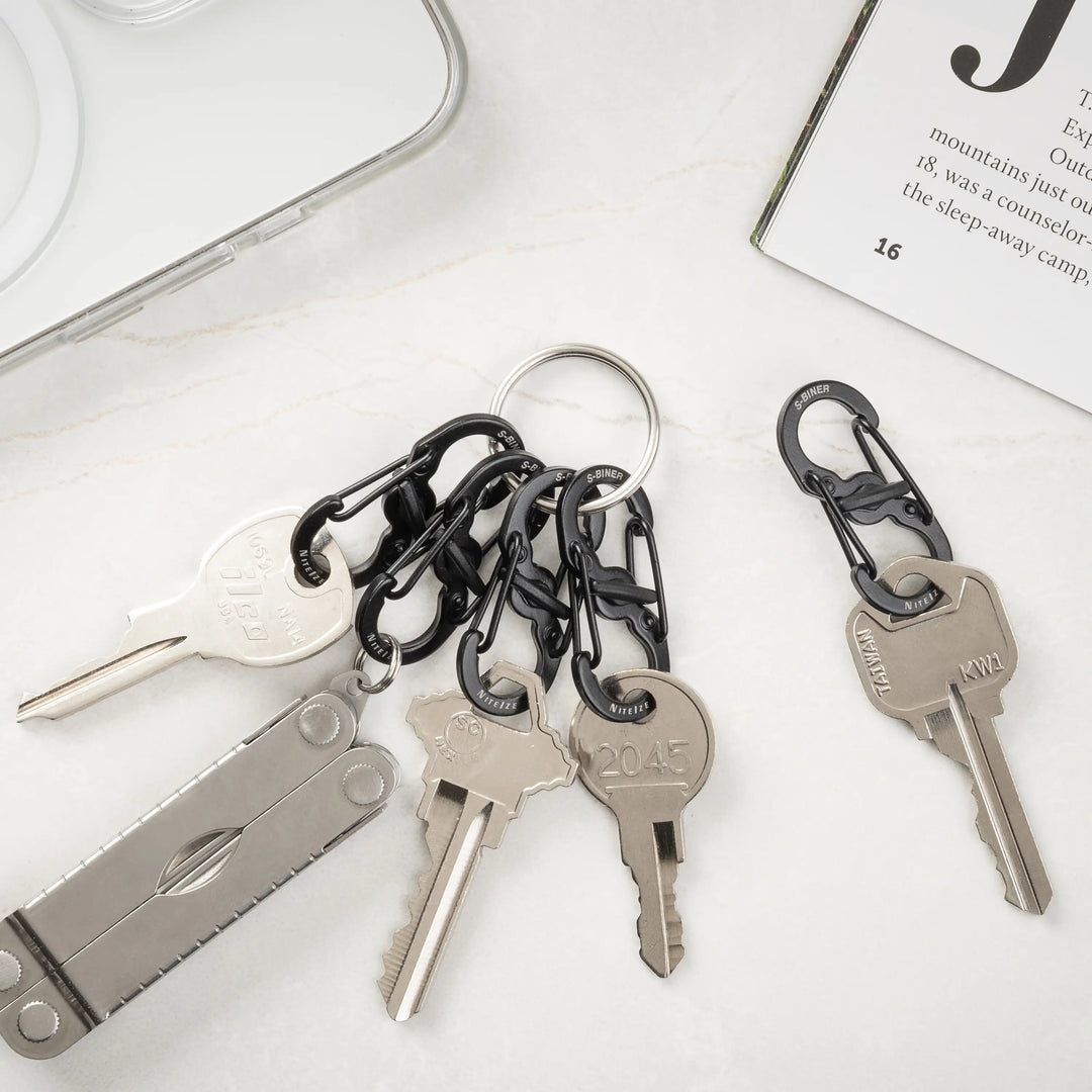 Keychain with keys and carabiners on a white surface
