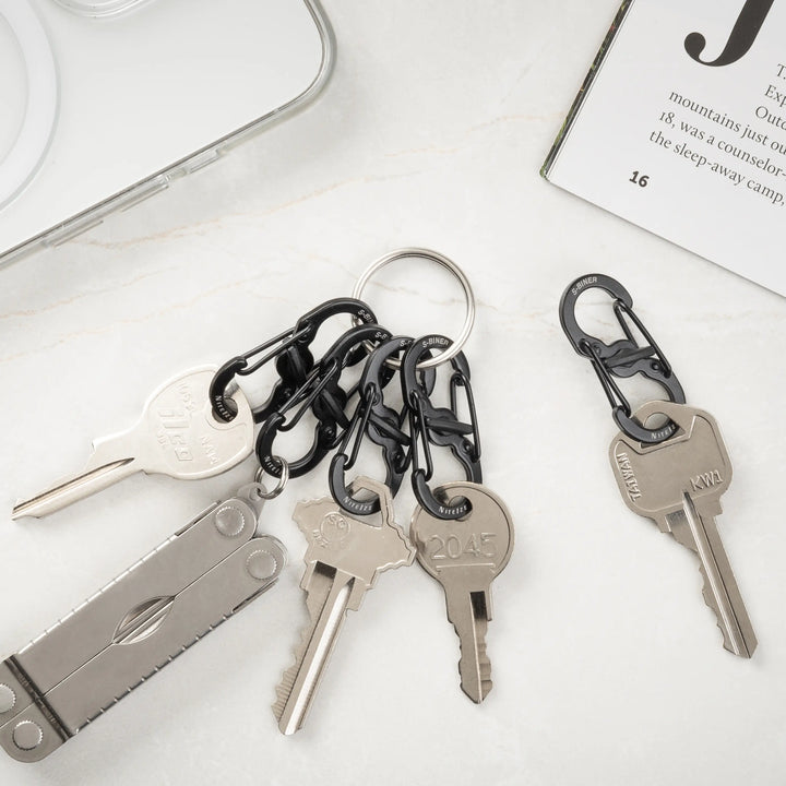 Keychain with keys and carabiners on a white surface