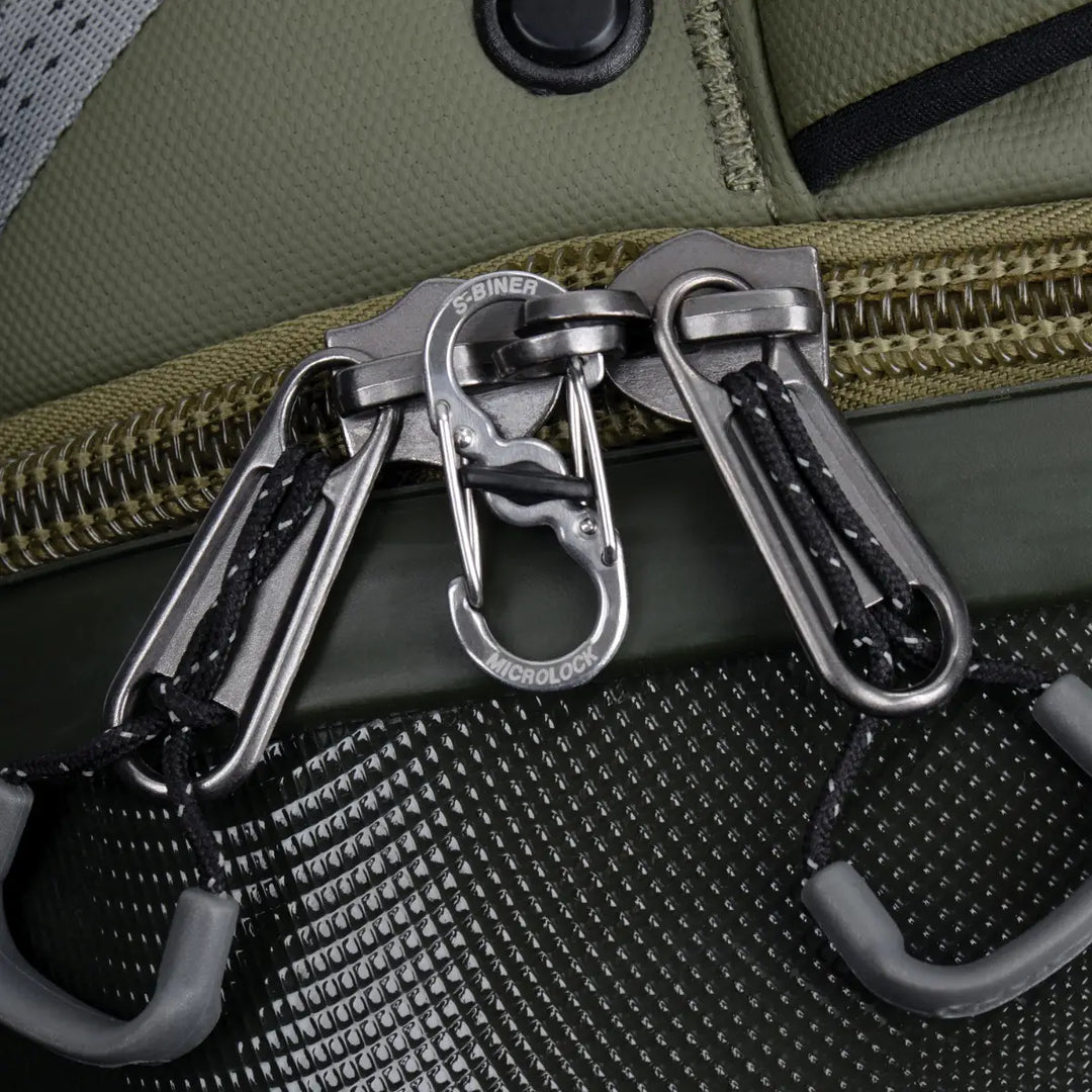 Close-up of a green bag with multiple carabiners attached