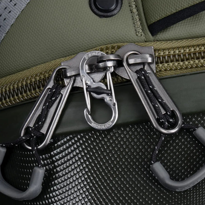 Close-up of a green bag with multiple carabiners attached