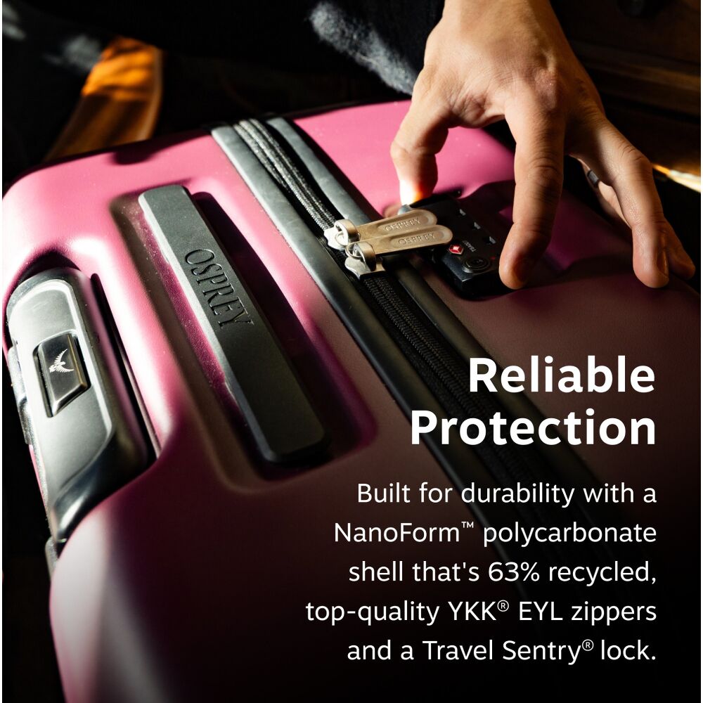 A close-up of a hard-shell suitcase with a hand locking the zipper. The image features a black text overlay on the right side reading &