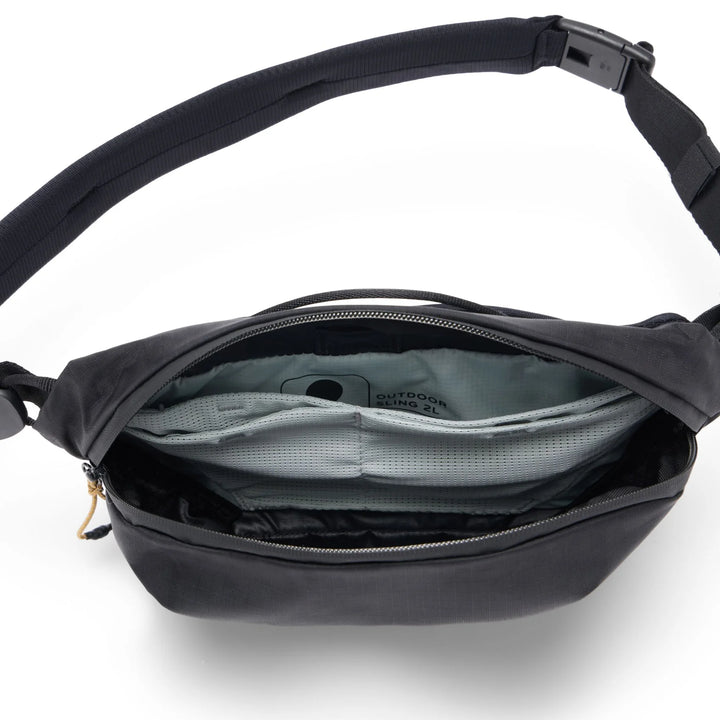 Black crossbody bag with open compartment on a white background