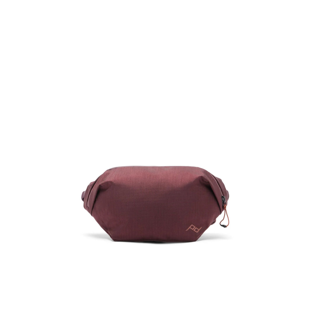 Maroon waist bag on a white background