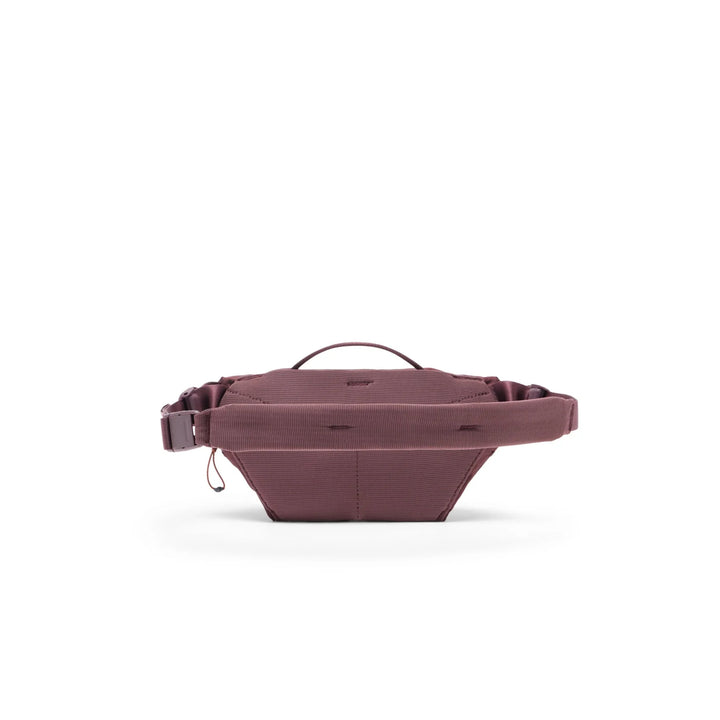 Back of maroon waist bag on a white background