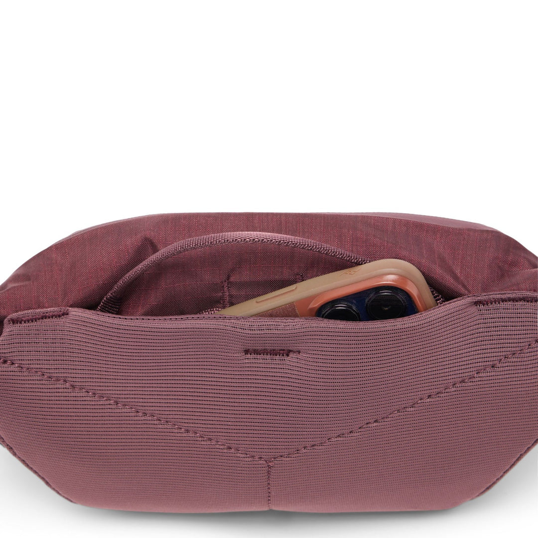 Maroon waist bag with phone and wallet inside on a white background