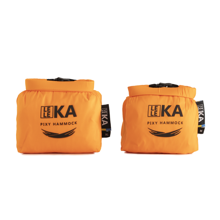 Two bright orange Leleka Pixy Hammock bags shown side by side on a plain white background, each with black printed branding and a small black side tag.