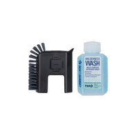 Black brush and bottle of Wilderness Wash on a white background