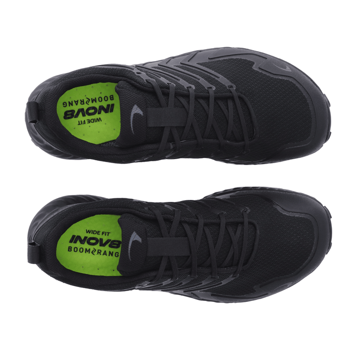 Birdseye view of a pair of black running shoes with green insoles