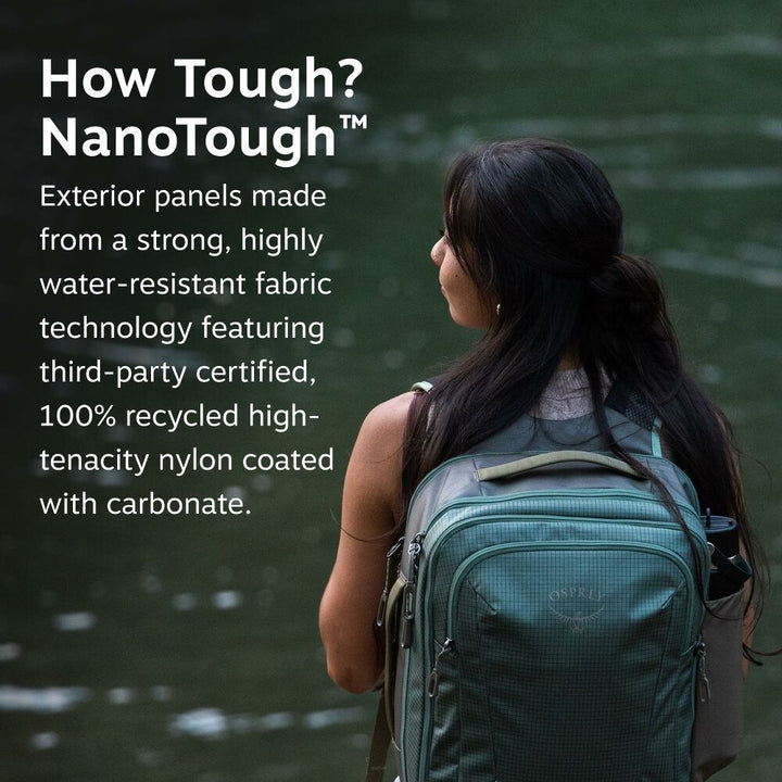 A woman seen from behind wearing a dark green NanoTough backpack, standing by a body of water with promotional text on the left side of the image.