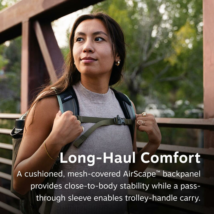 Woman with a backpack outdoors, highlighting comfort features of the backpack.