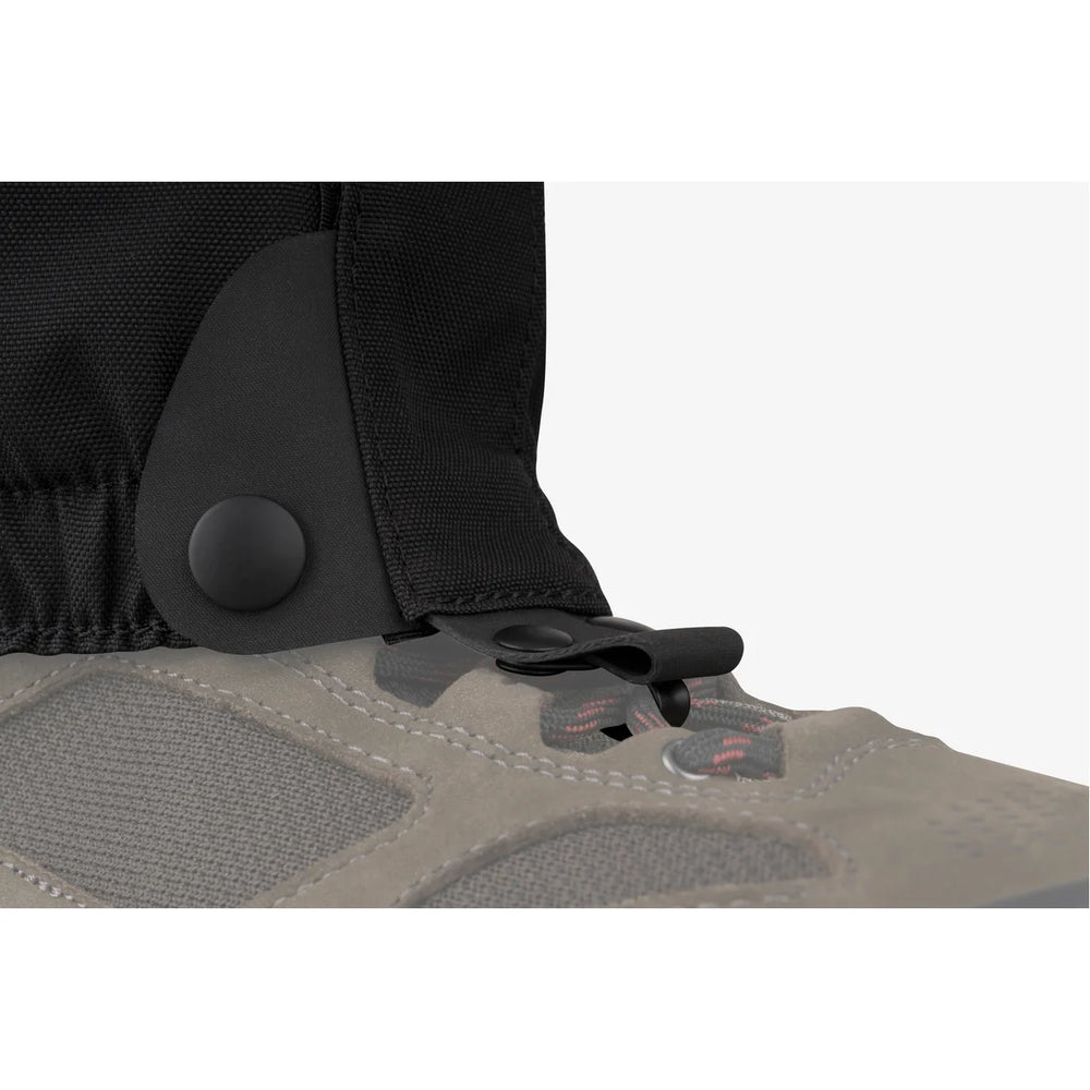 Close-up of a shoe with a black gaiter on a white background