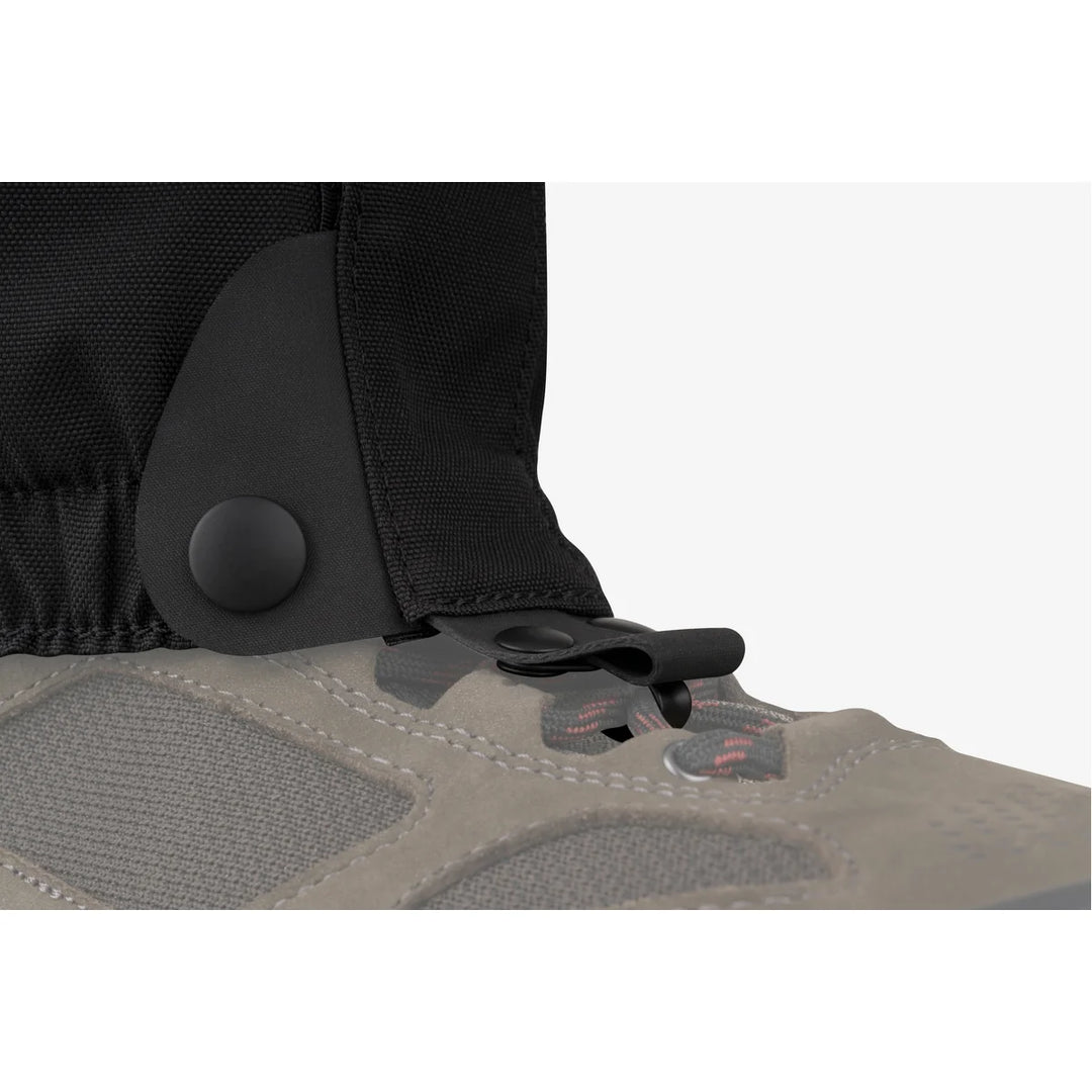 Close-up of a shoe with a black gaiter on a white background