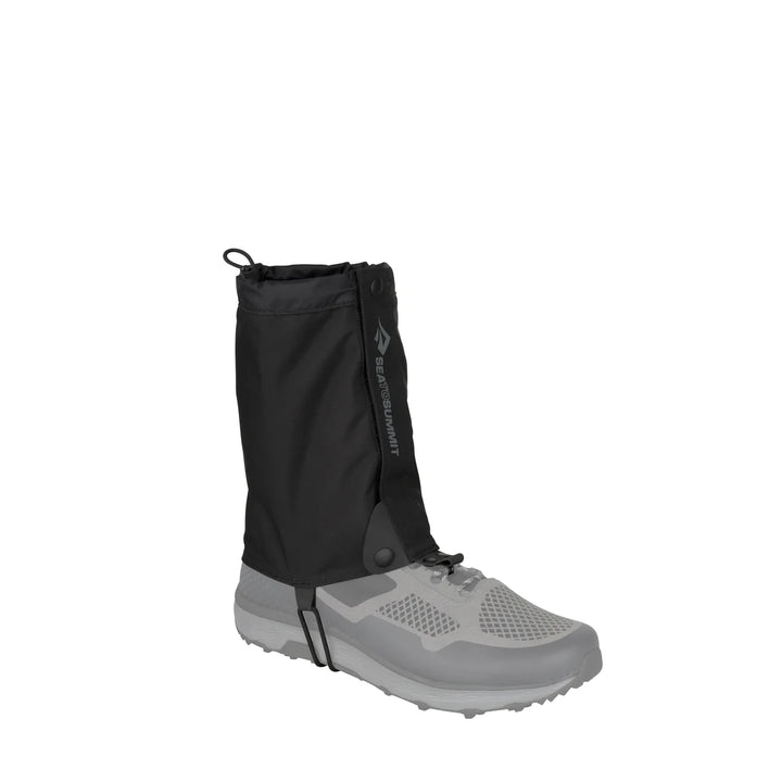 Black gaiter attached to a gray shoe on a white background