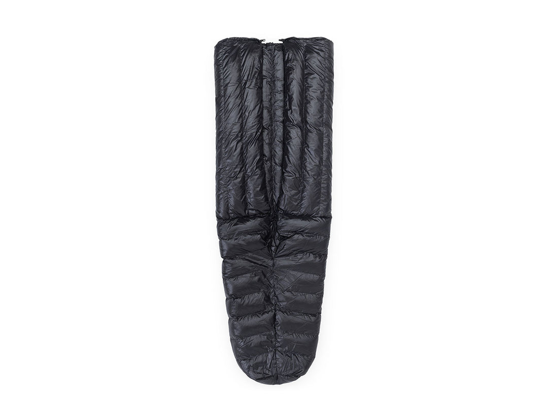 Black sleeping bag on a beige background