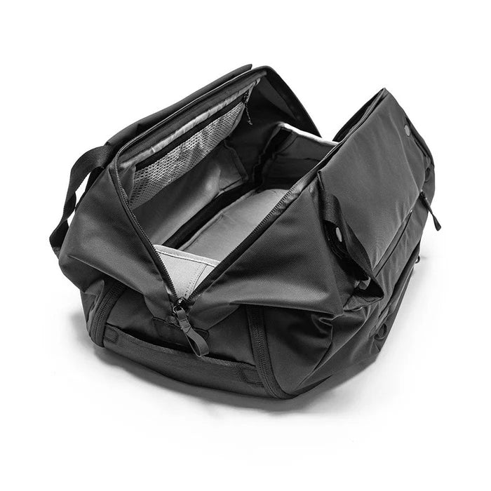 Black backpack with open front compartment on a white background