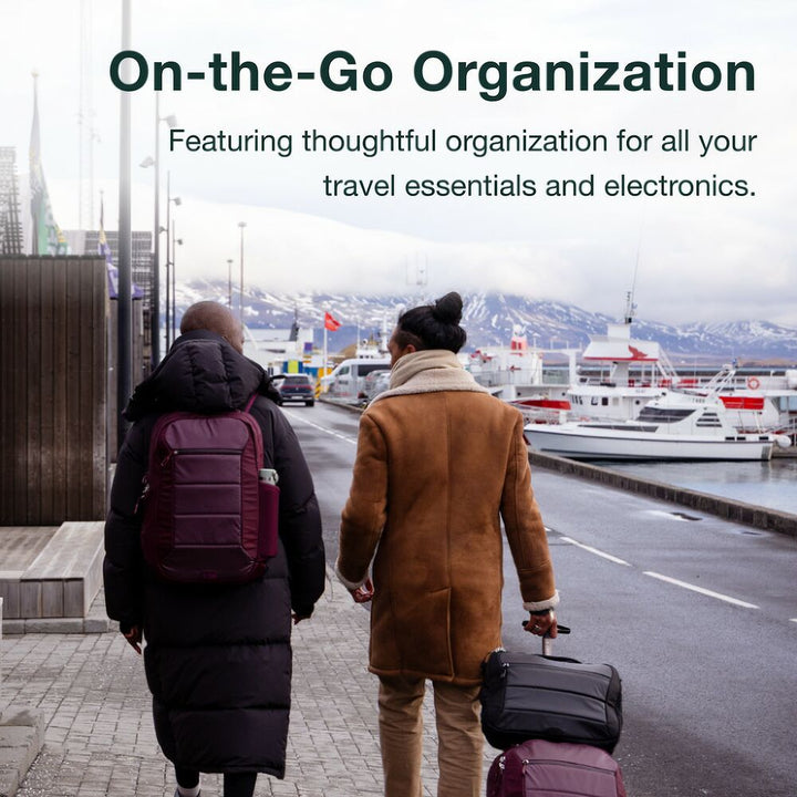 Two people walking with luggage and backpacks on a city street, with text about travel organization.