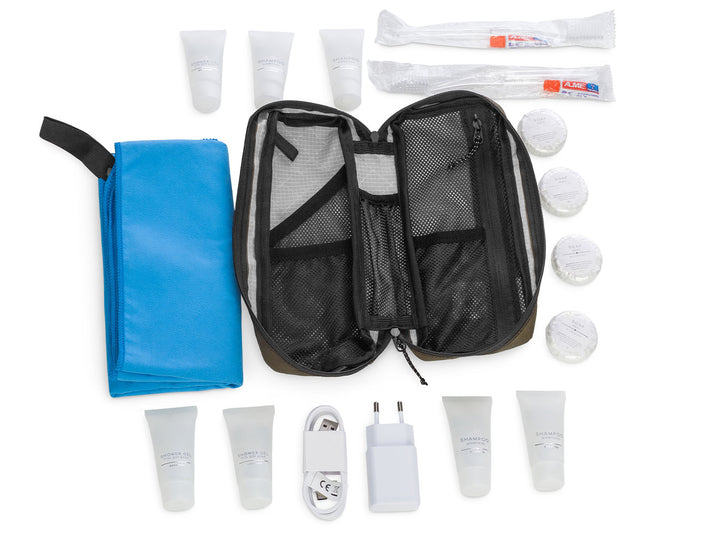 Travel kit with toiletries and electronic devices on a white background